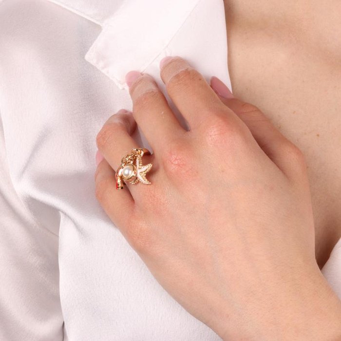 Bague en métal avec étoile de mer et cristal