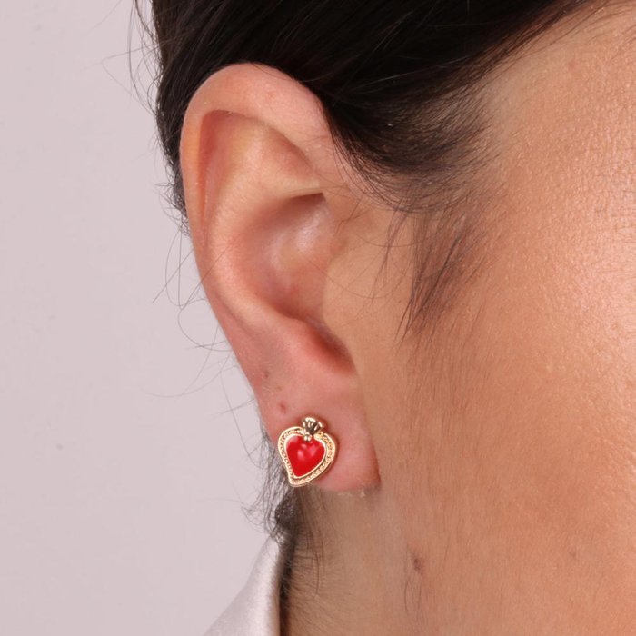 Metal earrings with sacred heart on lobe