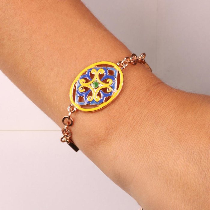 Metal bracelet with white crystals and central detail in blue and yellow enameled flower majolica